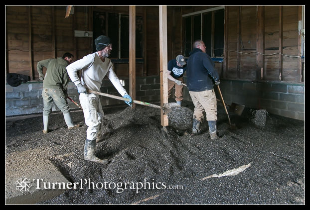 Crew spreads and levels the gravel by hand.