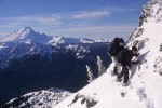 0100083 Zack Nowak, Mimi Allin traverse steep snow-covered ridge to Goat Mtn. east summit. Mt. Baker Wilderness Goat Mtn., WA. © Mark Turner