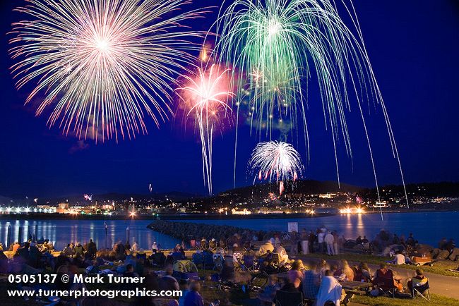 0505086 People spread on lawn awaiting fireworks. Bellingham, Zuanich Point Park, WA. © Mark Turner