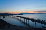 0700148 Taylor Dock over Bellingham Bay w/ walkers, Fairhaven shipyards & Lummi Island bkgnd at sunset. Bellingham, Boulevard Park, WA. © Mark Turner