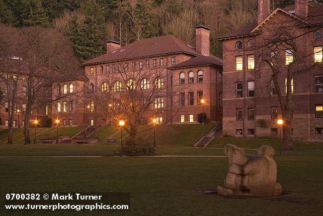 0700382 Old Main w/ sculpture 'The Man Who Used to Hunt Cougars for Bounty' (Richard Beyer) fgnd, dusk. Bellingham, Western Washington University, WA. © Mark Turner