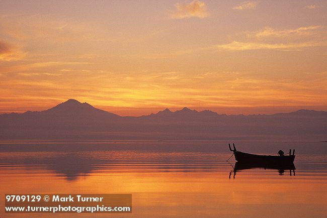 9709129 Pre-sunrise glow over Mt. Baker & Twin Sisters reflected in Bellingham Bay w/ small fishing boat. Lummi Shore Rd, WA. © Mark Turner