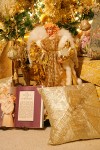 0910672 Doll in gold dress among pillows & book at base of Gold Christmas tree. Mary Etta Foster, Ferndale, WA. © Mark Turner