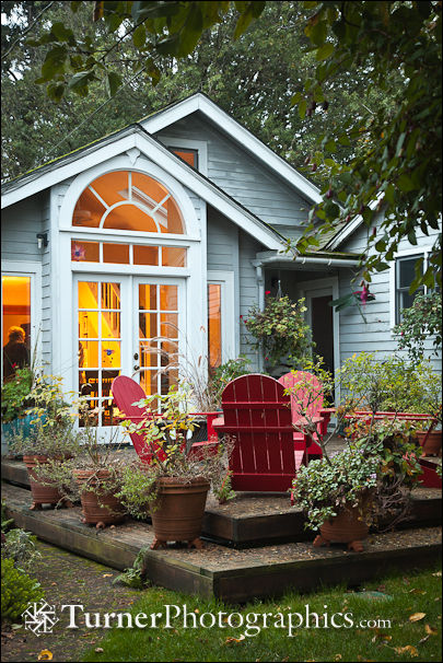 Red chairs on deck behind home