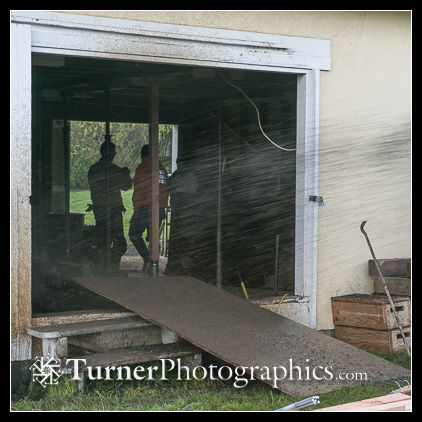 Pea gravel shooting through the old barn door into the studio.
