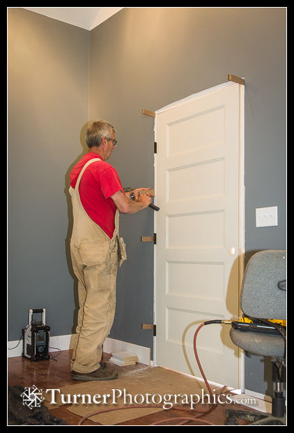 Mike Gill adjusts fit of door