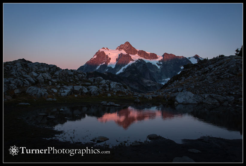 Mt. Shuksan reflected in small tarn at sunset