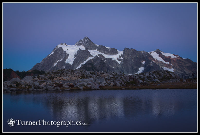 Mt. Shuksan reflected in small tarn at dusk