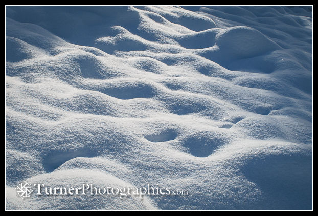 Pattern of light and shadow on fresh snow