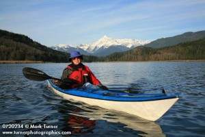 0720234 Joy Church paddles kayak on Lake Shannon w/ Mt. Shuksan bkgnd. Lake Shannon, WA. © Mark Turner